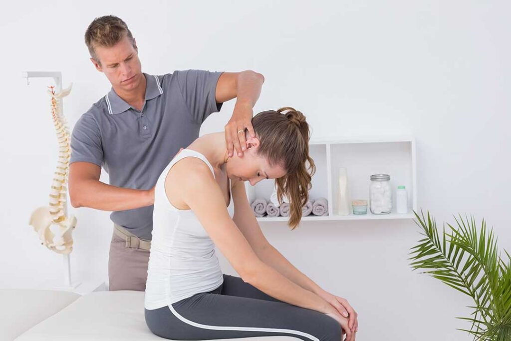 Patient discusses neck pain and treatment risks with a healthcare provider in a bright examination room.